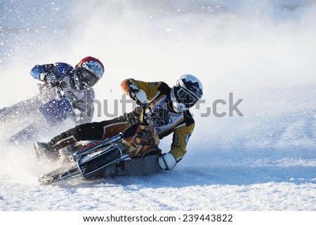 NOVOSIBIRSK, RUSSIA - DECEMBER 20, 2014: Unidentified bikers during the semi-final individual rides of Russian Ice Speedway Championship. The sports returns to the sport arenas after a decline
