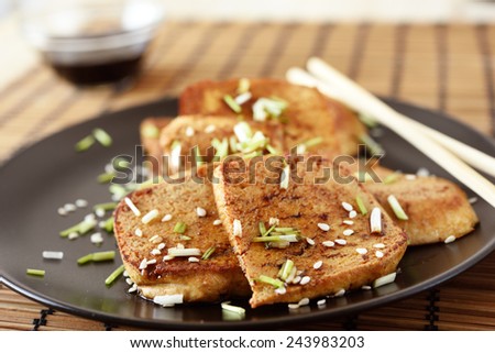 Fried tofu with sesame seeds, chives, and soy sauce