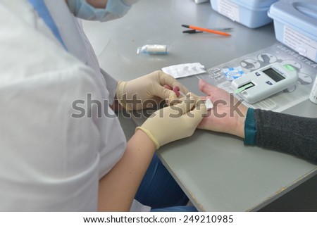 NOVOSIBIRSK, RUSSIA - DECEMBER 4, 2014: Nurse taking blood test in the Health Center. Health Centers are operated since 2010 and aimed to disease prevention