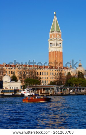 VENICE, ITALY - DECEMBER 31, 2012: Water taxi against St. Mark\'s Campanile. Water taxi is the best way to make city tour in Venice