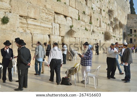JERUSALEM, ISRAEL - MARCH 20, 2014: Jews pray under the Western Wall in the Old city. The Old City is listed as UNESCO World Heritage site since 1981