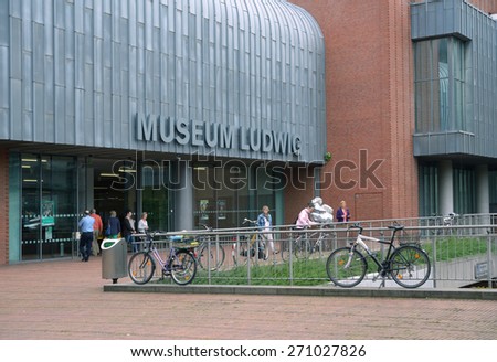 COLOGNE, GERMANY - JUNE 30, 2013: People in front of the Museum Ludwig. Emerged in 1976 after the chocolate magnate Peter Ludwig endowed 350 modern artworks, it houses a large collection of modern art