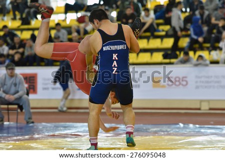 ST. PETERSBURG, RUSSIA - MAY 6, 2015: Esbolat Nurzhumbayev of Kazakhstan against unidentified Russian athlete during International freestyle wrestling tournament Victory Day