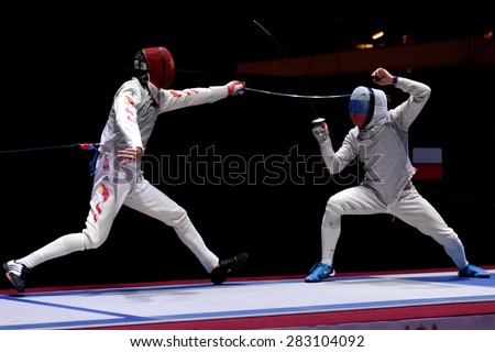ST. PETERSBURG, RUSSIA - MAY 3, 2015: Alexey Cheremisinov of Russia vs Sheng Lei of China in the team final match of 41th International fencing tournament St. Petersburg Foil, the stage of World Cup