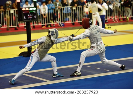 ST. PETERSBURG, RUSSIA - MAY 2, 2015: Erwan Le Pechoux of France vs Haiwei Chen of China in 1/8 final of International fencing tournament St. Petersburg Foil. The tournament is the stage of World Cup