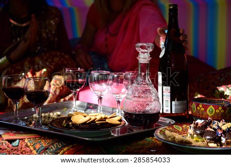 ST. PETERSBURG, RUSSIA - JUNE 4, 2015: Participants at a table with wine and sweets during the festival Emperor\'s Gardens of Russia. The exposition Silk Road Gardens is in focus of festival this year