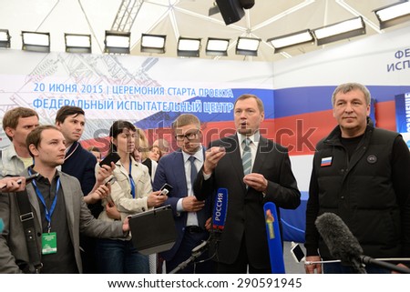 ST. PETERSBURG, RUSSIA - JUNE 20, 2015: General director of JSC Rosseti Oleg Budargin (center) talks with press during the presentation of the project of Federal Test Center for electrical equipment
