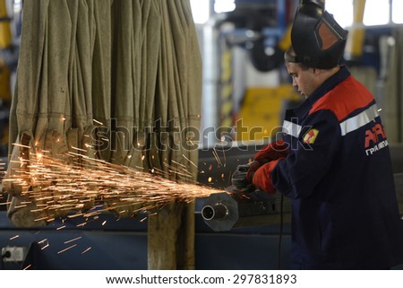 ST. PETERSBURG, RUSSIA - JUNE 30, 2015: Worker at work in the Megapolis plant owned by Amira Group. It\'s Russia\'s largest plant producing the lighting poles