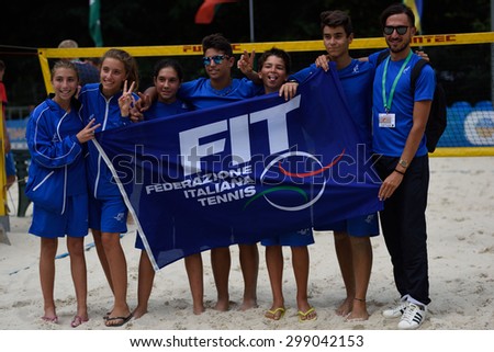 MOSCOW, RUSSIA - JULY 19, 2015: Junior team Italy with the flag of FIT during the ITF Beach Tennis World Team Championship. Italy become world champion in this first Junior Championship
