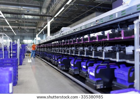 ST. PETERSBURG, RUSSIA - OCTOBER 30, 2015: Staff working in the automated mail sorting center of Russian Post. Russian Post is a strategic enterprise with 42,000 post offices and 351,000 employees