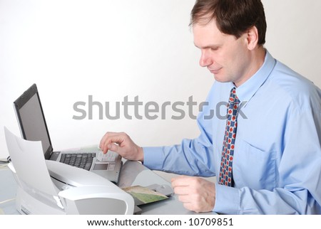 Man with printer and laptop on white background