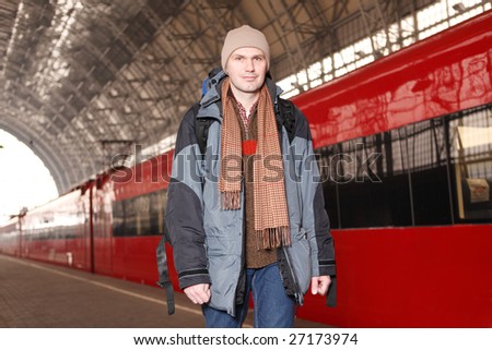 Man with backpack at the train station