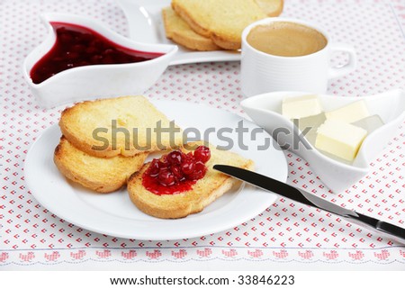 Breakfast with toasts, sour cherry jam, butter, and coffee