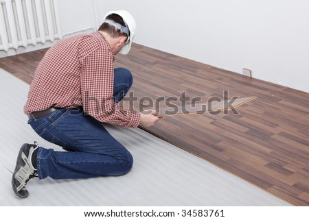 Man making the laminate flooring installation