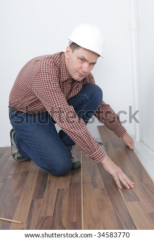 Man making the laminate flooring installation