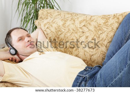 Relaxing man with headphones on a sofa