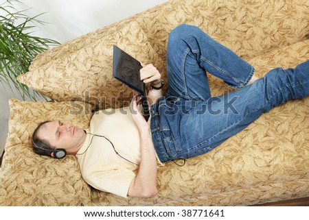Relaxing man with laptop on a sofa