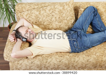 Relaxing man with headphones on a sofa