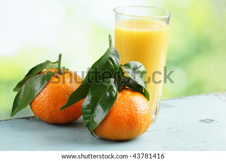 Mandarin orange and a glass of orange juice