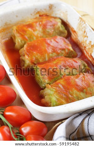 Stuffed cabbage with tomato sauce in white casserole