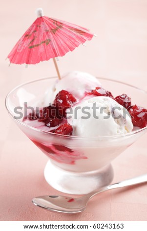 Sundae with cherry jam and drink umbrella
