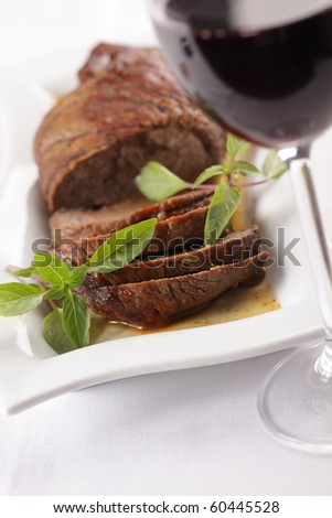 Roast beef with basil leaf and red wine