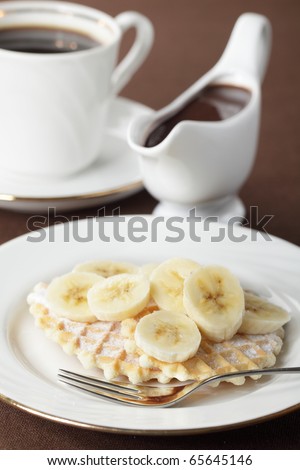 Waffle with banana and chocolate sauce closeup