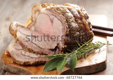 Roast beef and spices on the wooden cutting board