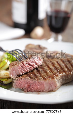 Medium rare T-bone steak with roasted leek and red wine