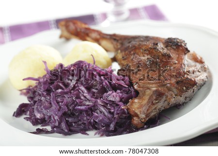 Roasted goose leg with potato dumplings and braised cabbage
