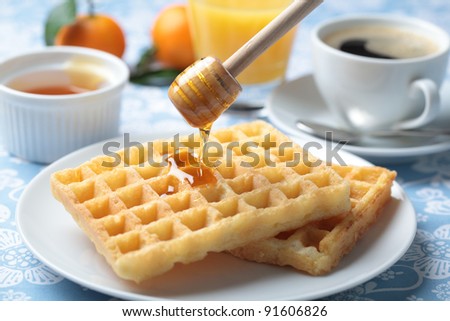 Breakfast with Belgian waffles, honey, orange juice and coffee