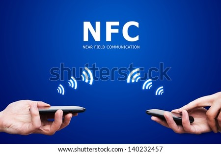 Hand holding smartphone with NFC technology - near field communication payment method