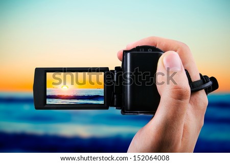 Video camera or camcorder recording sunset