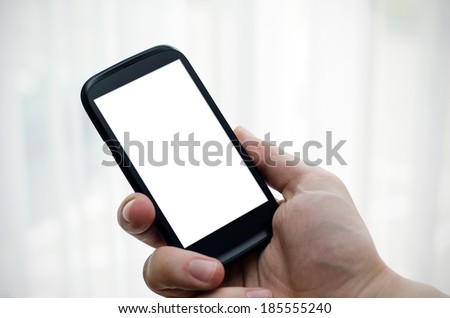 Hand holding mobile phone with blank display