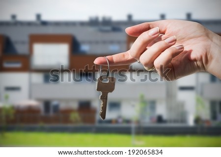 Woman\'s hand holding keys to new house