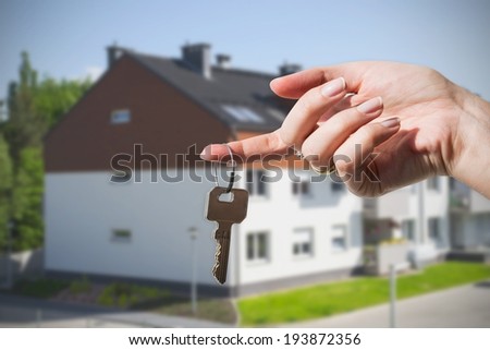 Woman\'s hand holding keys to new house