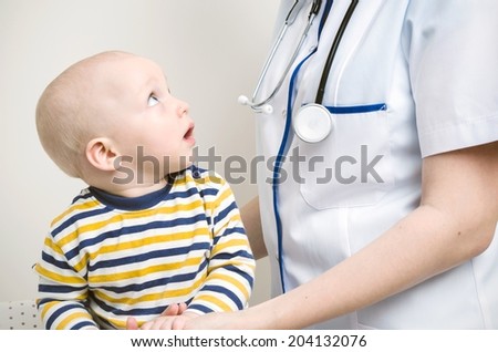 Baby looking at doctor Baby looking at doctor