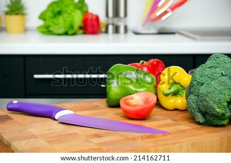 Fresh vegetables on a chopping board in the kitchen