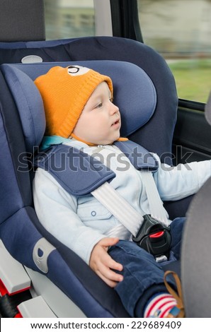 Cute boy sitting in the car seat