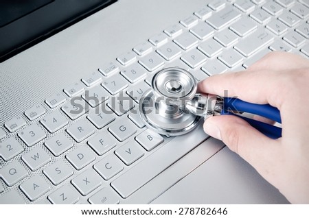 Diagnosis and repair of computers. Stethoscope on laptop
