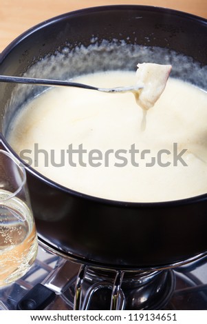 Cheese fondue with bread, wine and grapes