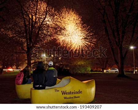 OTTAWA - MAY 17: Young people sit in giant Dutch wooden shoes to watch fireworks display over Dow\'s Lake; part of the Canadian Tulip Festival held in Ottawa on May 17, 2014.