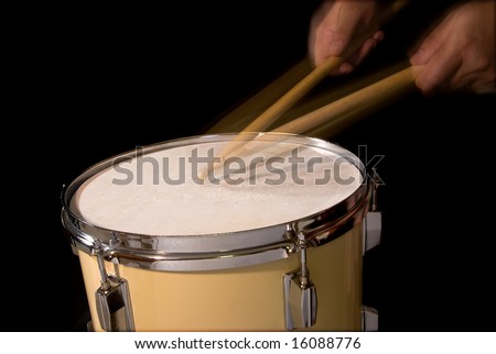 Drum roll played on a tom drum; motion blur of sticks and hands; isolated on black
