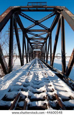 Perspective view along the prince of wales railway bridge in ottawa in winter