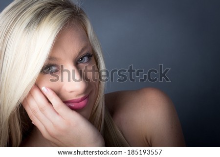 Sensual Blond Female holding her face with her hand