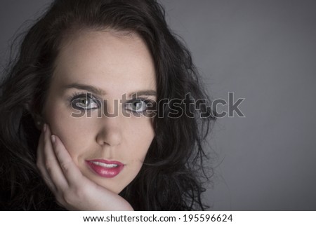 Sensual Black hair green eyes model with red