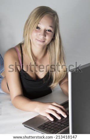 Young Teenager using her laptop to research