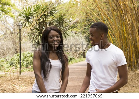 Young Loving Black couple talking in a park