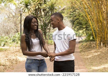 Young Black woman closing her eyes while boyfriend propose