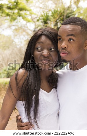 Young Black couple in a loving embrace at the park